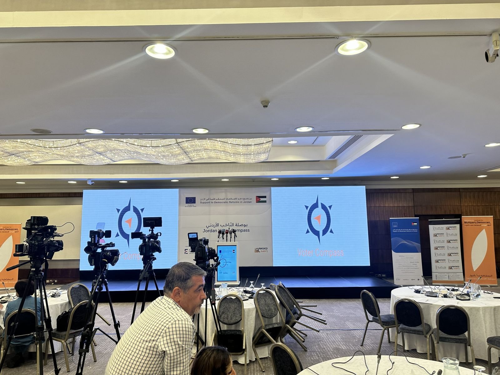 Conference stage with LED screens and camera crews